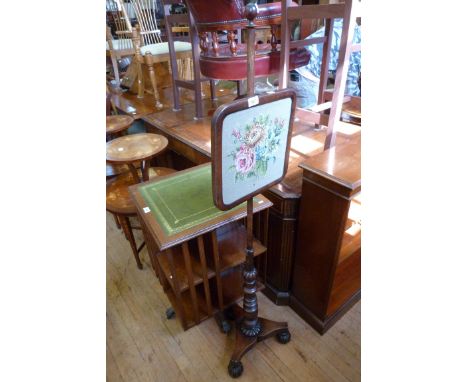 A Victorian mahogany pole screen decorated with floral tapestry panel