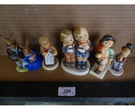 A collection of four Goebel models of children together with a further Royal Doulton Bunnykins model (5)