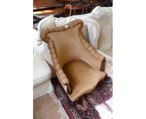 An Edwardian cabriole legged light brown upholstered armchair