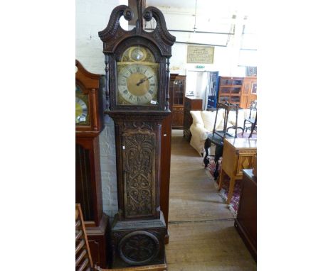 A 20th Century reproduction longcase clock in dark finish composition case with foliage detail 