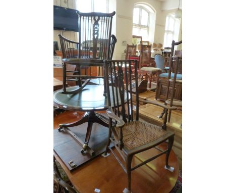 A small early 20th Century cane seat and stick back rocking chair together with a further cane seated side chair (2)