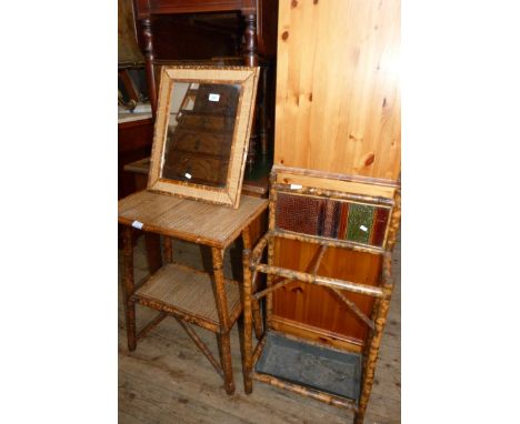 A mixed lot of bamboo furniture comprising a stick stand, a two tier table and a wall mirror (3)