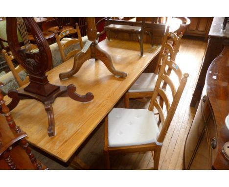 An Ercol decorative contemporary pine dining suite comprising refectory table raised on lyre form supports, together with fou