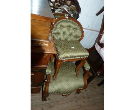 A Victorian walnut framed green upholstered button back armchair and accompanying cabriole legged stool (2)