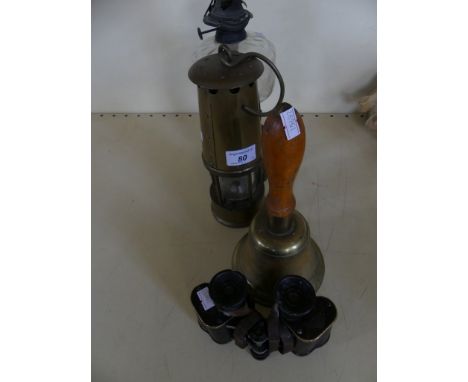 A mixed lot comprising oil lamp, brass miners lamp, brass hand bell and pair of binoculars (4)