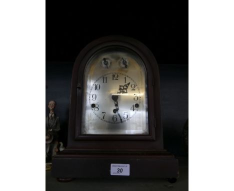 A 20th Century bracket clock with silver dial set in a stained hardwood case.