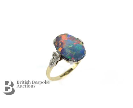 Antique 18ct yellow gold, platinum fire opal and diamond ring. The oval doublet measuring 13.5 x 10mm set with approx 9 pts o