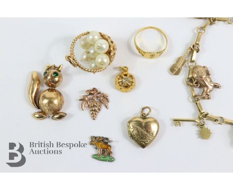 9ct gold charm bracelet, with a number of 9ct gold charms including a clover leaf, motor boat, rabbit, key, bell, Star of Dav