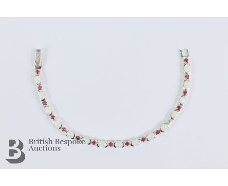 Silver ruby and opal line bracelet, approx 20 cms in length, approx 13.9 gms.&nbsp;