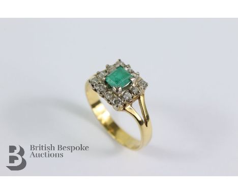 18ct yellow gold emerald and diamond ring. The square-cut emerald measuring 5 x 4.3mm, framed by approx 18 pts of dias, size 