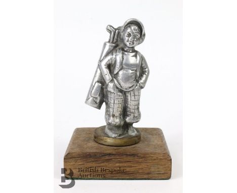 An unusual 'Golf Caddy Boy' accessory mascot for a 1920's vintage motorcar; together with a 'Lady Golfer in Full Swing', both