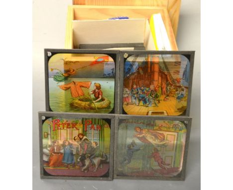 "PETER PAN." a set of 24 coloured glass magic lantern slides, No 1 being titled "Peter Pan.", early 20th century in a wooden 