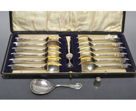 A Silver caddy spoon, Joseph Gloucesterm Birmingham 1897;  a silver thimble; a set of twelve EPNS tea spoons and sugar tongs,