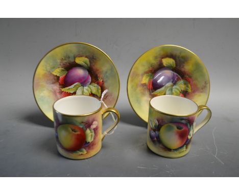 A pair of hand painted Minton coffee cans and saucers