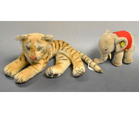 A Steiff (Germany) grey mohair elephant, 8317/00, grey felt pads, red saddlecloth with gilt brass bells, black and white butt