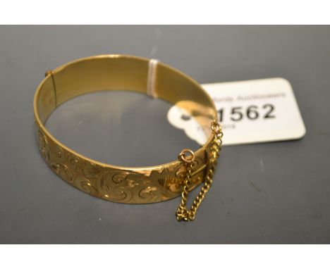 A gold plated hinged bangle, one fifth 9ct, by Gilerco