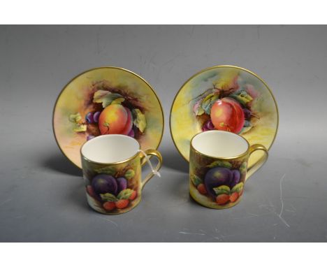 A pair of hand painted Minton coffee cans and saucers
