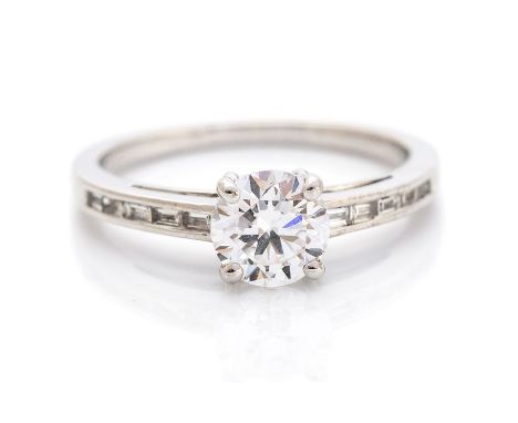  A diamond solitaire white gold ring, diamond set shoulders, the round brilliant cut diamond accompanied by a GIA diamond rep