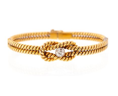 A diamond solitaire two-row hinged bangle, the central rub-over set old-cut diamond weighing approx 0.50ct, assessed colour F