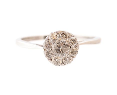 A diamond round cluster white gold ring, illusion set with brilliant cut diamonds, total diamond weight 0.75 ct, (stamped to 