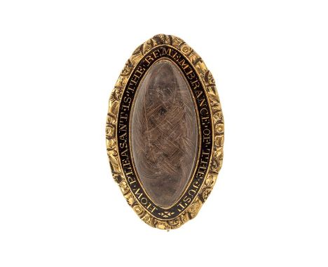 An 18th/19th century navette shaped gilt metal and enamel mourning brooch, set with a plait of hair, the black enamel inscrib