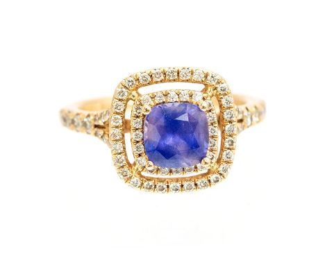 A sapphire and diamond ring, the cushion shaped purple sapphire weighing approx 1.20 carats, claw set to the centre with a do