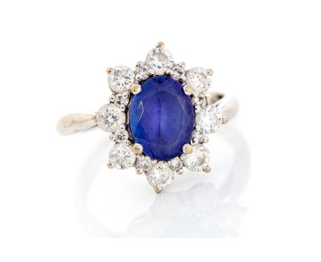 A tanzanite and diamond oval cluster 18ct white gold ring, the oval mixed-cut tanzanite approx 9mm x 7mm, calculated weight a