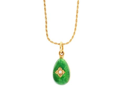 An 18ct yellow gold, enamel and diamond egg pendant, with blue and green guilloche enamel, set either side with a round brill