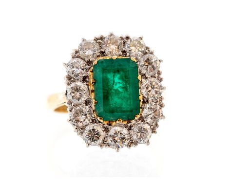 A 2 carat emerald and diamond cushion shaped cluster ring, the central step-cut emerald approx 9.2mm x 6.7mm, approx 2cts, th