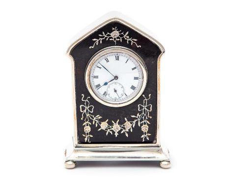 An Edwardian inlaid tortoiseshell and silver mounted desk / mantle clock, domed top on plinth base with bun feet, the body in