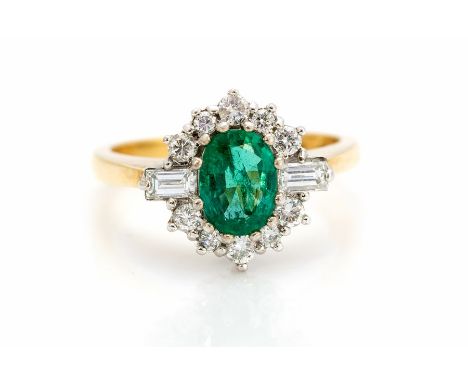 An emerald and diamond oval cluster 18ct gold ring, the central oval mixed cut emerald approx 8mm x 6mm, calculated weight ap