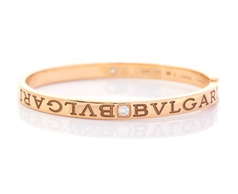 A Bvlgari diamond two-stone set 18ct yellow gold hinged bangle, two round brilliant cut diamonds carre set (one to each side)