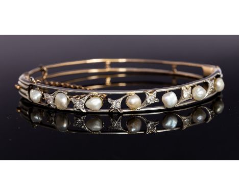 An Edwardian diamond and pearl set bangle, the open work top with fleur-de-lis details set with small diamonds along with alt
