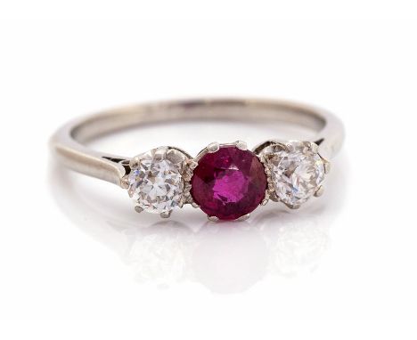 A diamond and ruby three stone ring, central round old Swiss cut ruby weighing approx  0.50ct, two round old cut diamonds one