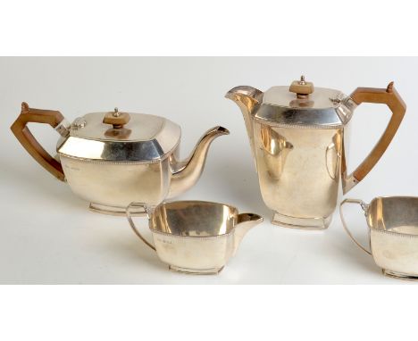 A Post War silver four piece tea service, each of bowed rectangular section, the tea pot and water jug with insulated handles