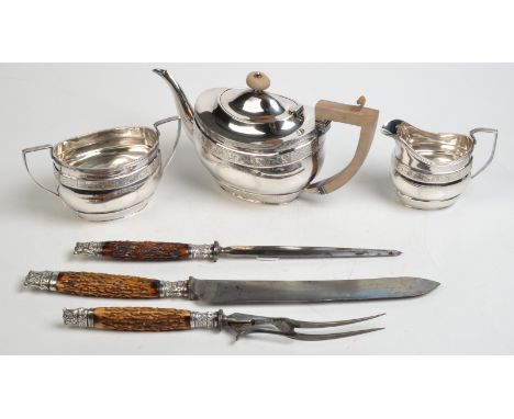 An engraved EPNS Georgian style three piece tea service of oval section, together with a three piece carving set.