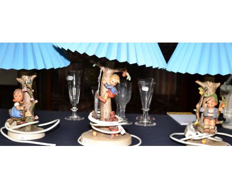 Three Hummel table lamps. Condition Report: In good condition with a couple of very minor glaze chips.