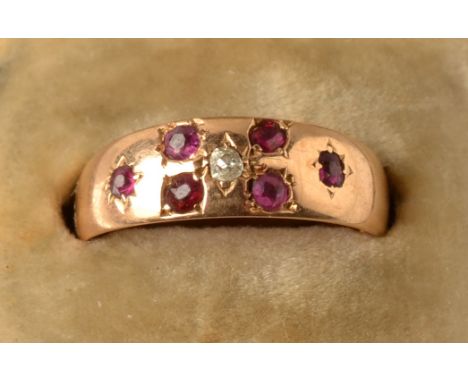 A 15ct. gold late Victorian ring gypsy set with a diamond and six rubies. Condition Report: Size L/M.  Good condition with su