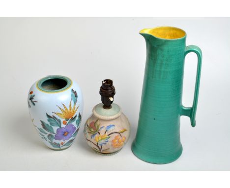 A Gouda Viola vase, height 17.5cm, together with a 1930's pottery table lamp and a Bretby lemonade jug. 