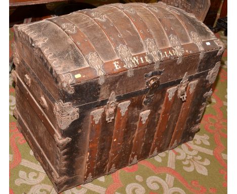 A domed, metal mounted, ship's trunk with fitted interior, ornamented with printed flowers.