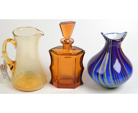 A Whitefriars amber glass jug, an Art Deco amber glass cut glass decanter in Moser style and a murano style vase.