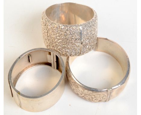 An ornate Victorian silver bangle, a Victorian silver Aesthetic Movement bangle and one other silver bangle. 