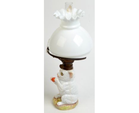 A German porcelain cat oil lamp, the kitten holds a ball and has glass eyes, the burner by Kosmos-Brenner, white glass shade,