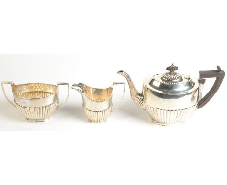An Edwardian half fluted silver three piece tea service, by Levi & Salaman, Birmingham, 1909, 33ozs.