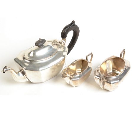 A George V bachelors' teapot, milk jug and sugar bowl of rounded octagonal section, Birmingham, 1911, retailed by Apsrey & Co