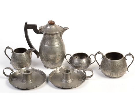 A pair of Arts & Crafts "Don Pewter" chamber sticks, an Arts & Crafts three piece pewter tea service and a pewter sugar bowl.