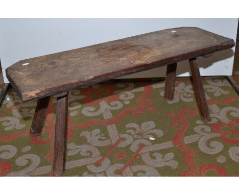 A country made low table or stool with chamfered splayed legs, length 90cm.