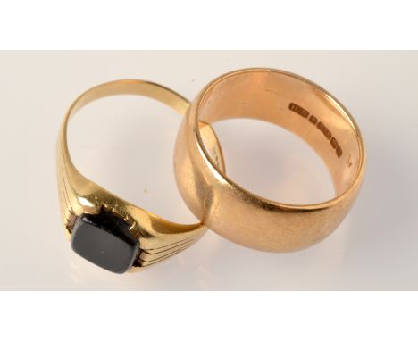 A 9ct. gold band and a 9ct. gold signet ring. Condition Report: The gold band is Q/R and the signet ring R. Total weight 10.8