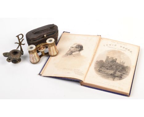 A pair of mother of pearl veneered opera glasses by Marchand, Paris cased. Together with a bronzed wick lamp and a book. 