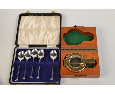 A reproduction compass in a wooden case, together with a part set of hallmarked silver spoons.